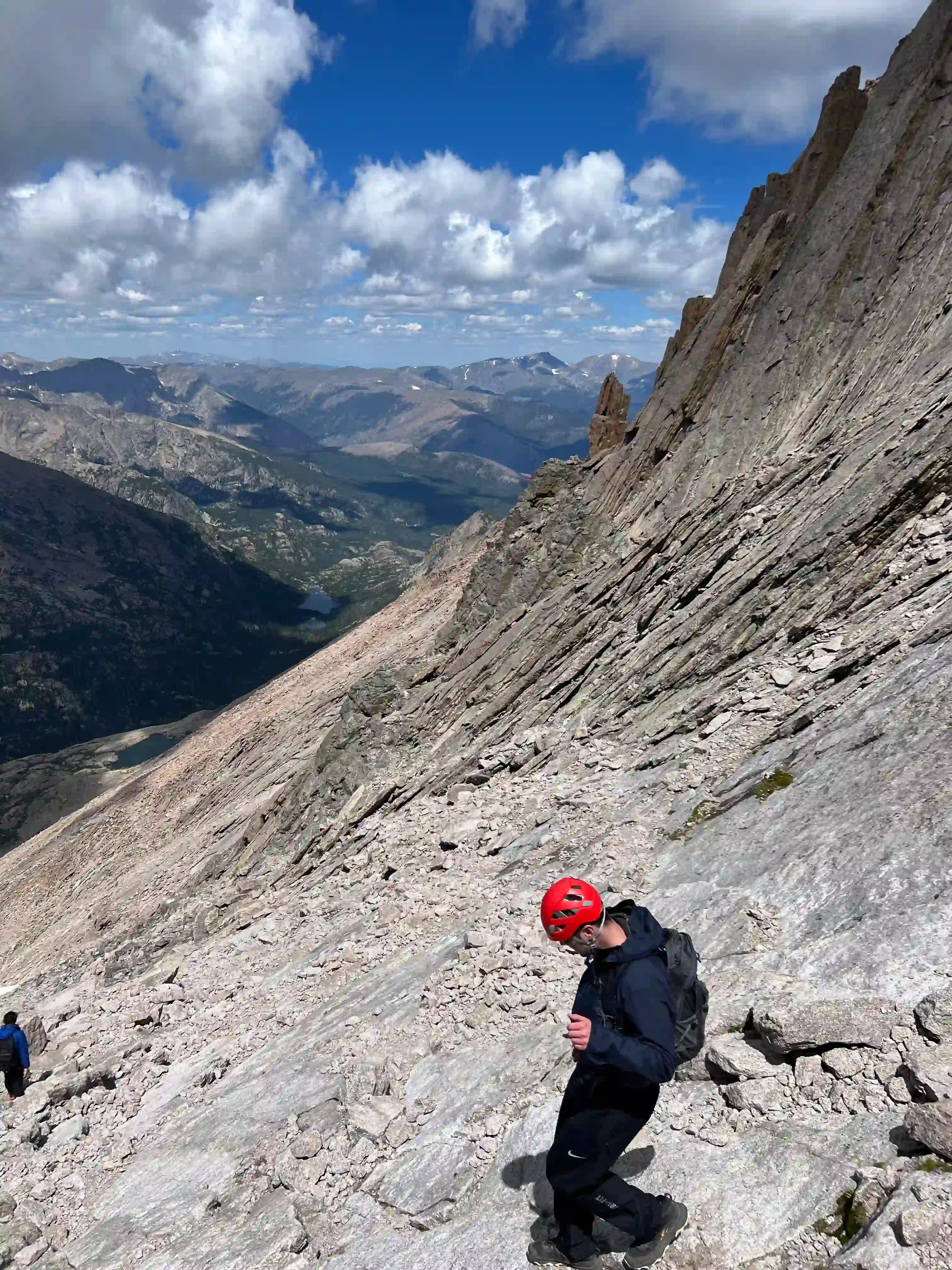 Man hiking down a steep Colorado mountain