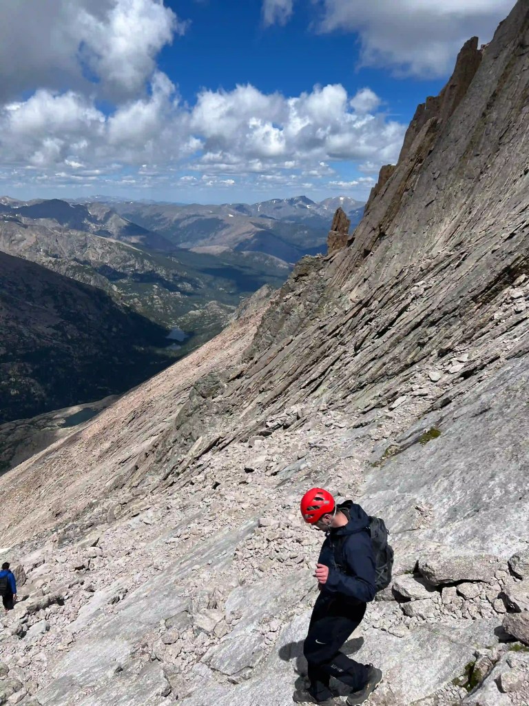 Man hiking down a steep Colorado mountain
