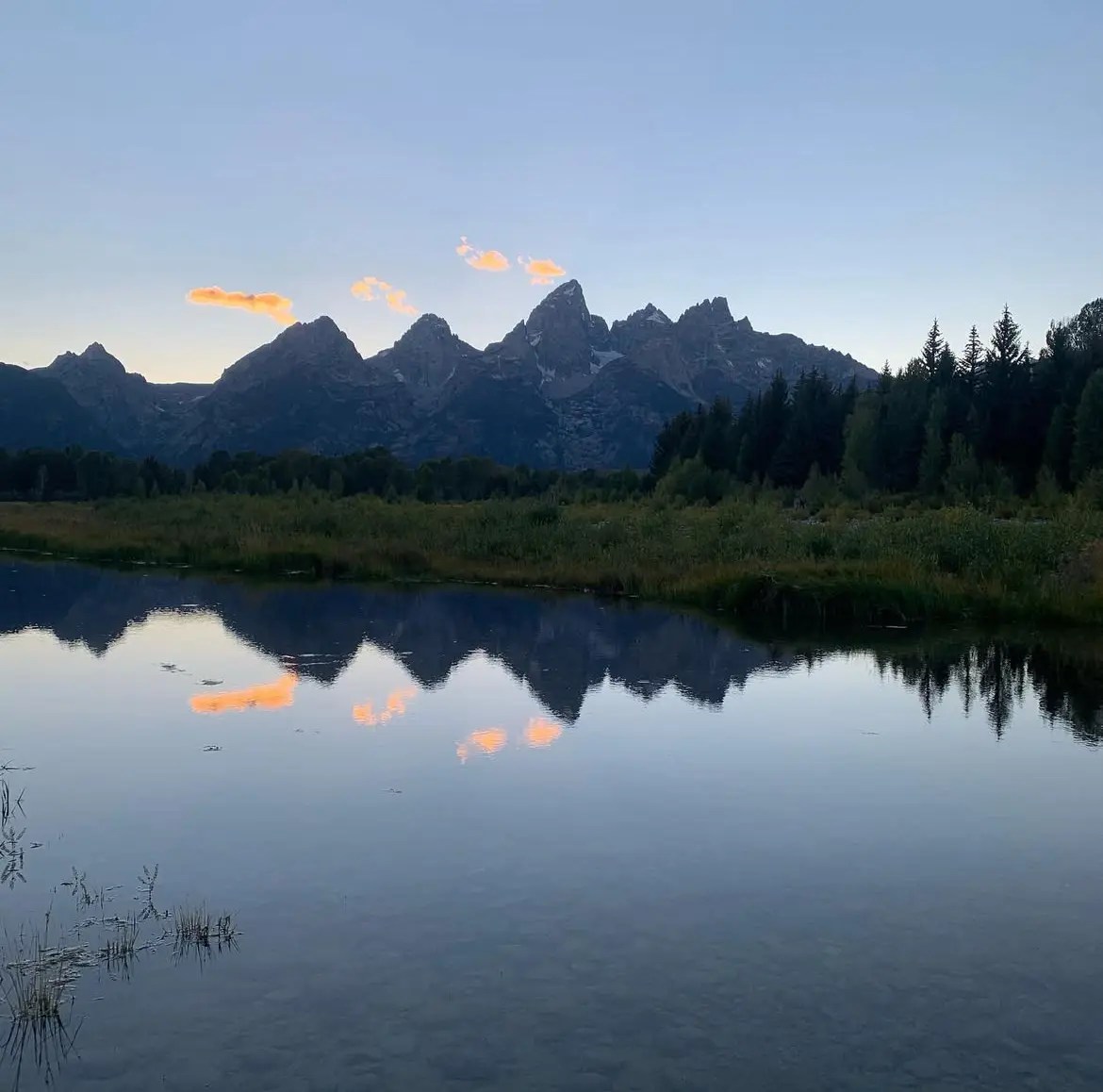 The Teton Mountains reflecting off a pond