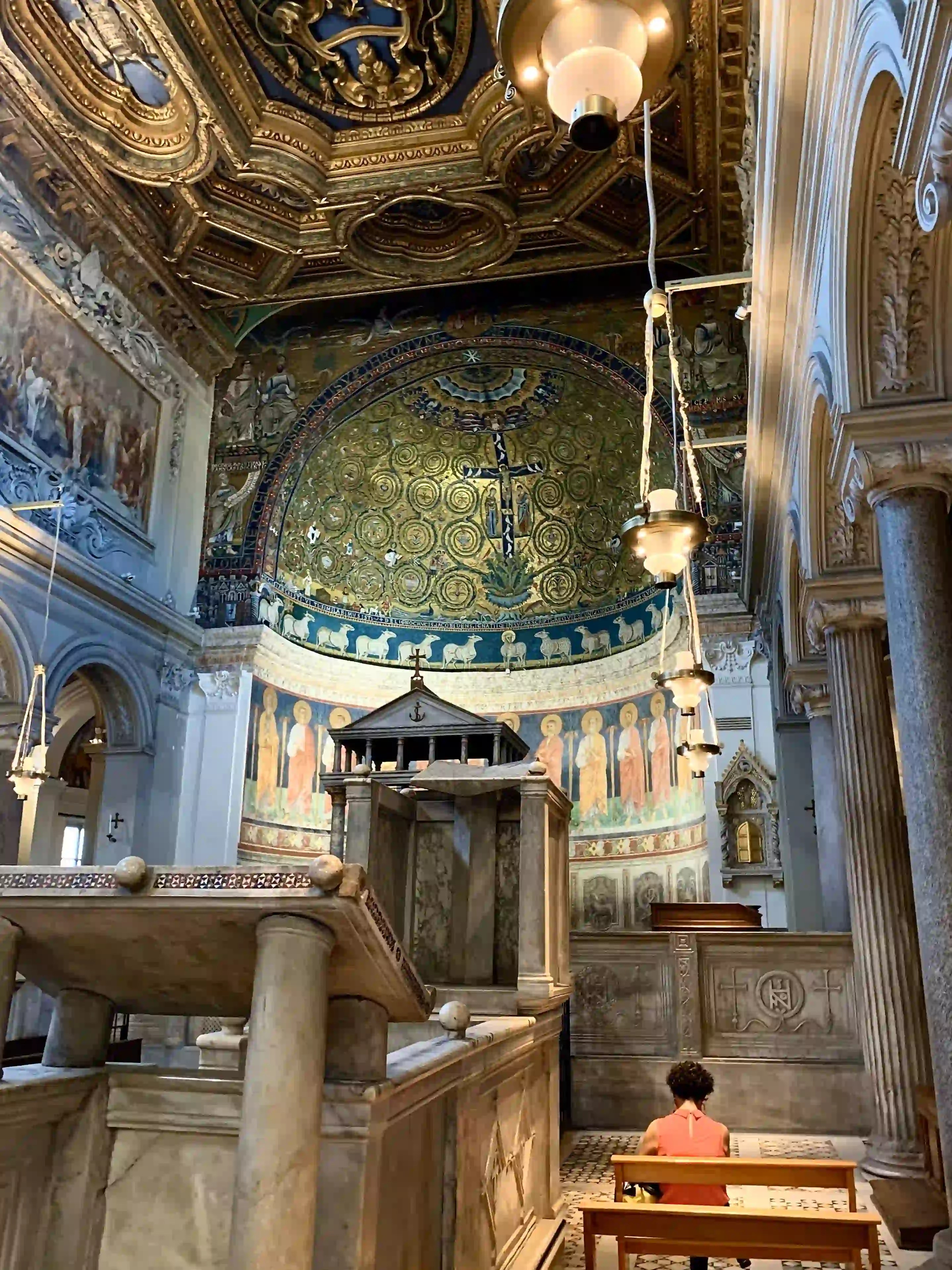 A woman sitting in a beautiful roman church